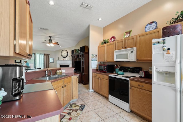 kitchen featuring light tile patterned floors, white appliances, a textured ceiling, a ceiling fan, and a sink