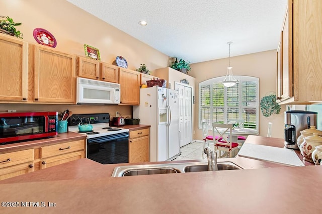 kitchen featuring white appliances, light countertops, a textured ceiling, a sink, and hanging light fixtures