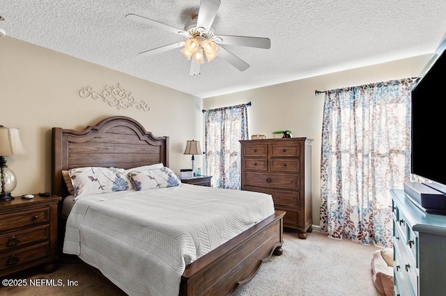 bedroom featuring ceiling fan, light carpet, and a textured ceiling