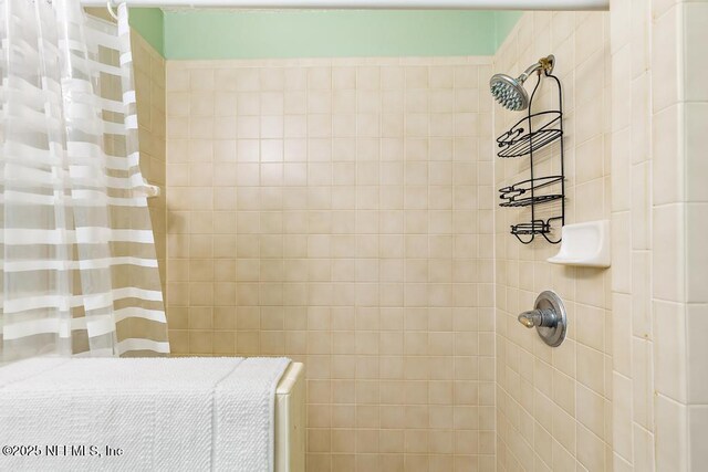 bathroom with a tile shower