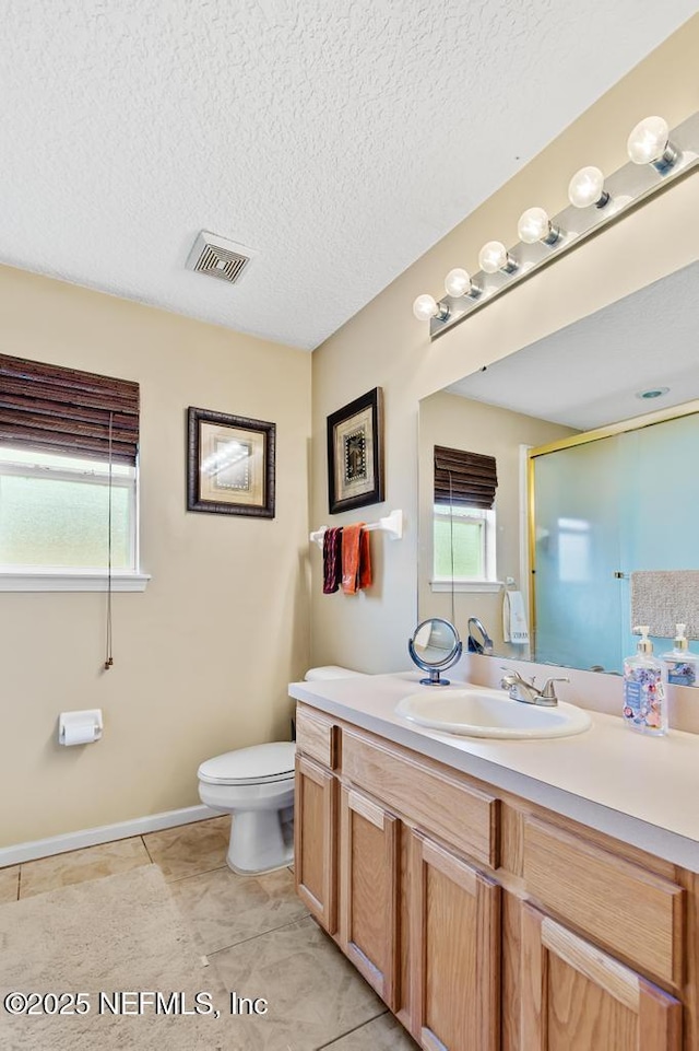 full bathroom featuring a wealth of natural light, vanity, visible vents, and toilet