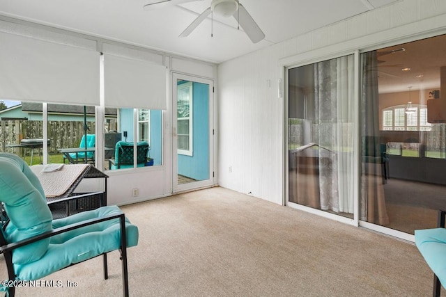 sunroom featuring ceiling fan