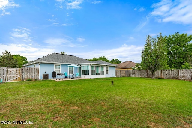 rear view of property with a patio area, a fenced backyard, and a yard