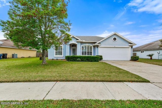 ranch-style house with a front yard, driveway, a garage, and stucco siding