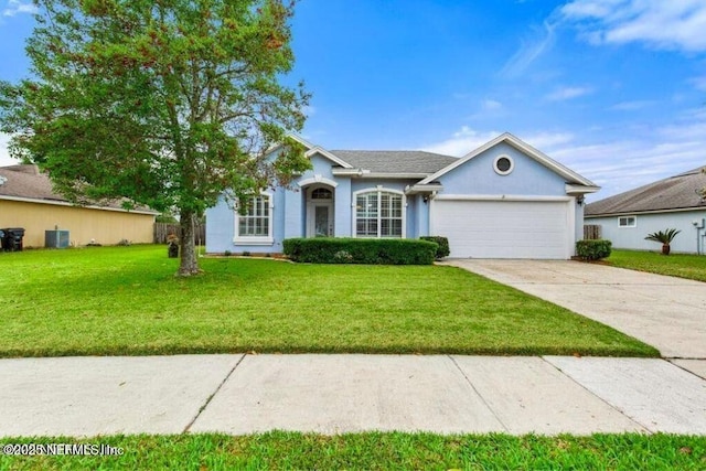 86446 Sand Hickory Trl, Yulee, FL 32097 - view of front of property featuring an attached garage, concrete driveway, a front lawn, and stucco siding