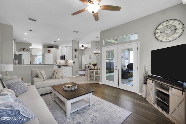 living room featuring visible vents, wood finished floors, french doors, and a ceiling fan