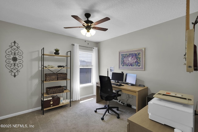 office featuring carpet flooring, a textured ceiling, baseboards, and ceiling fan