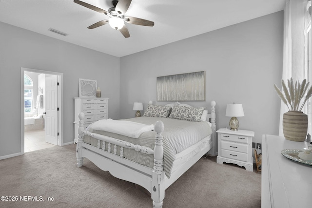 bedroom featuring carpet floors, ensuite bathroom, baseboards, visible vents, and ceiling fan