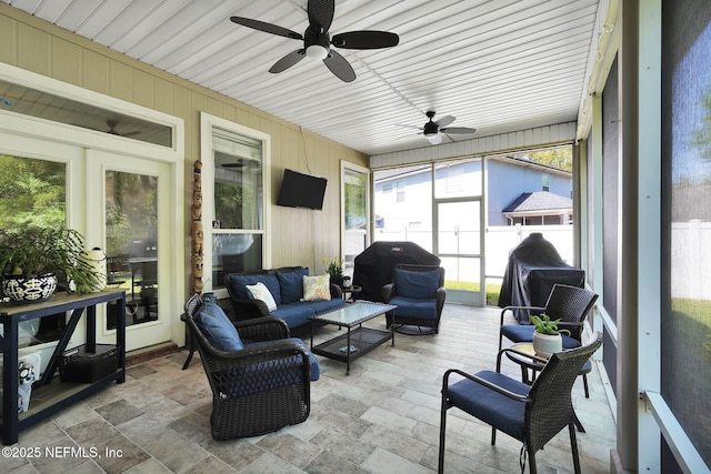 sunroom featuring an outdoor living space and ceiling fan