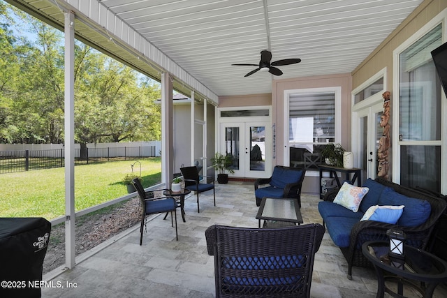 sunroom featuring ceiling fan and french doors