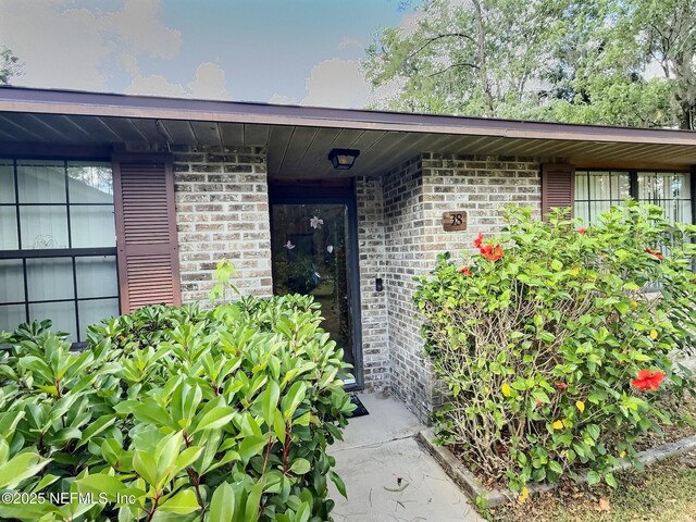 38 Rymer Ln, Palm Coast, FL 32164 - doorway to property featuring brick siding