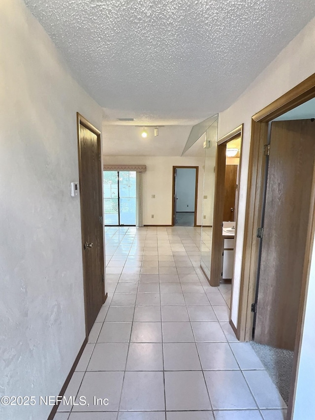 38 Rymer Ln, Palm Coast, FL 32164 - corridor with light tile patterned flooring and a textured ceiling