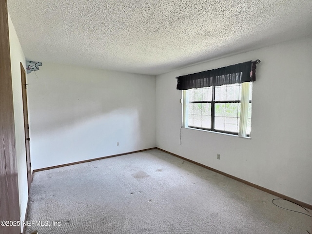 38 Rymer Ln, Palm Coast, FL 32164 - empty room featuring carpet floors, a textured ceiling, and baseboards