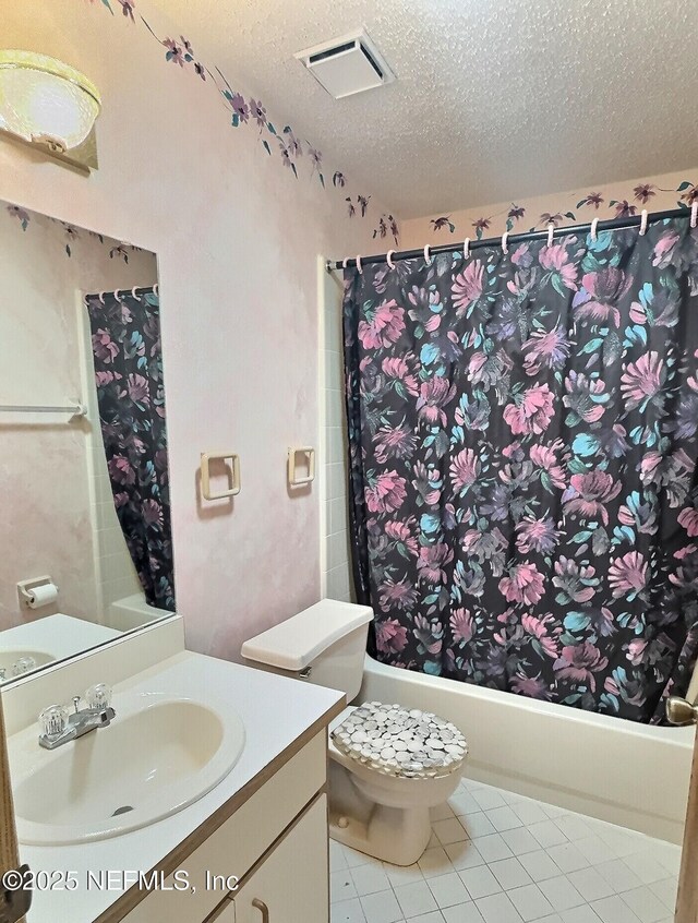 38 Rymer Ln, Palm Coast, FL 32164 - full bathroom with vanity, toilet, a textured ceiling, shower / bath combo with shower curtain, and visible vents