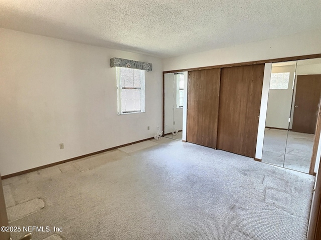 38 Rymer Ln, Palm Coast, FL 32164 - unfurnished bedroom featuring baseboards, light carpet, a closet, and a textured ceiling