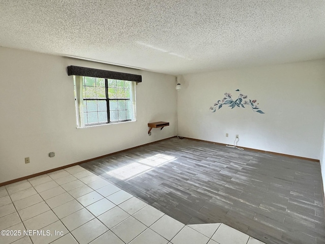 38 Rymer Ln, Palm Coast, FL 32164 - empty room with baseboards, a textured ceiling, and wood finished floors