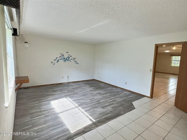 38 Rymer Ln, Palm Coast, FL 32164 - unfurnished room featuring light wood-type flooring, a textured ceiling, and baseboards