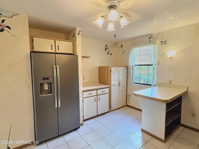 38 Rymer Ln, Palm Coast, FL 32164 - kitchen with open shelves, ceiling fan, stainless steel refrigerator with ice dispenser, light countertops, and a textured ceiling
