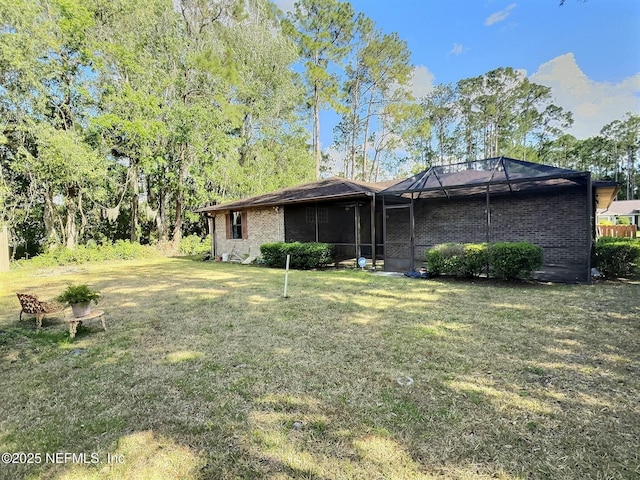 38 Rymer Ln, Palm Coast, FL 32164 - rear view of house featuring a lawn and a lanai