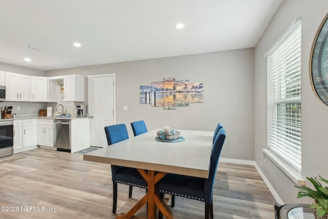 dining space with recessed lighting, baseboards, and light wood-type flooring