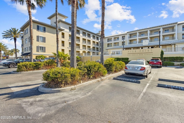 view of building exterior featuring uncovered parking
