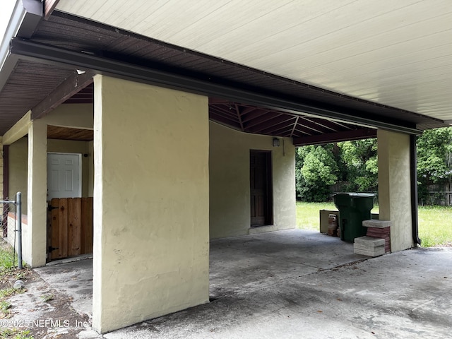 exterior space featuring an attached carport and stucco siding
