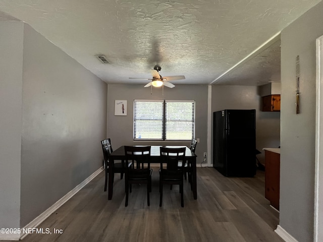 dining space with wood finished floors, ceiling fan, baseboards, and visible vents