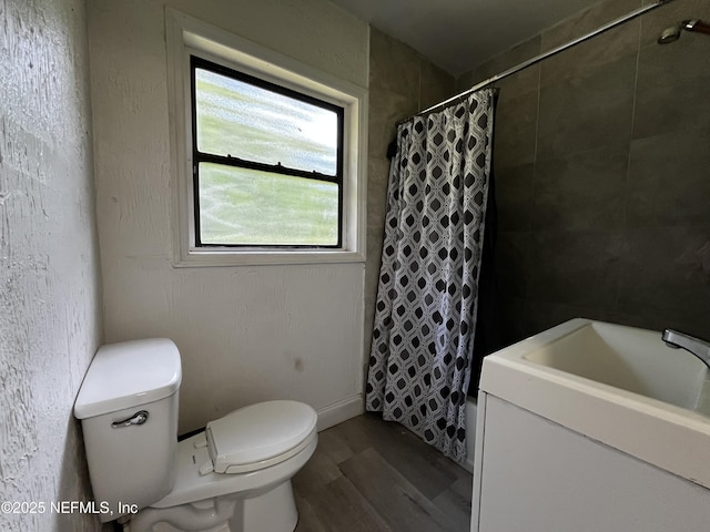 full bathroom with toilet, wood finished floors, and a shower with shower curtain