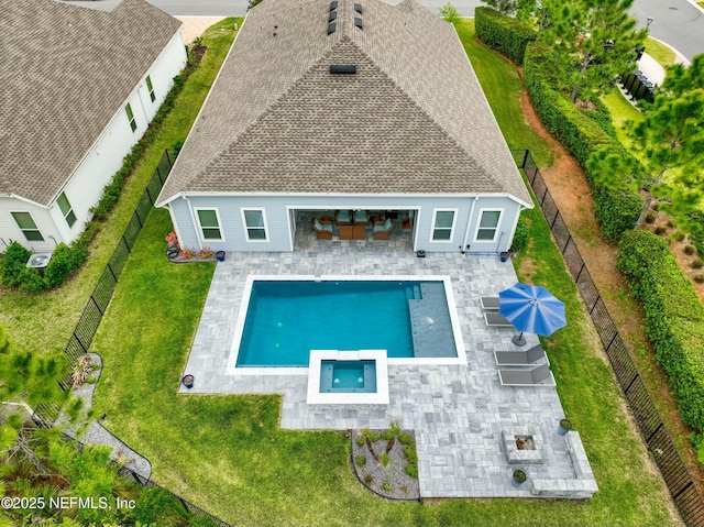 rear view of house featuring a fenced backyard, a yard, and a patio