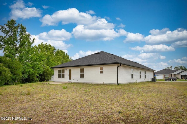 7271 Gateway Ct, Jacksonville, FL 32219 - back of house with central AC unit and a lawn