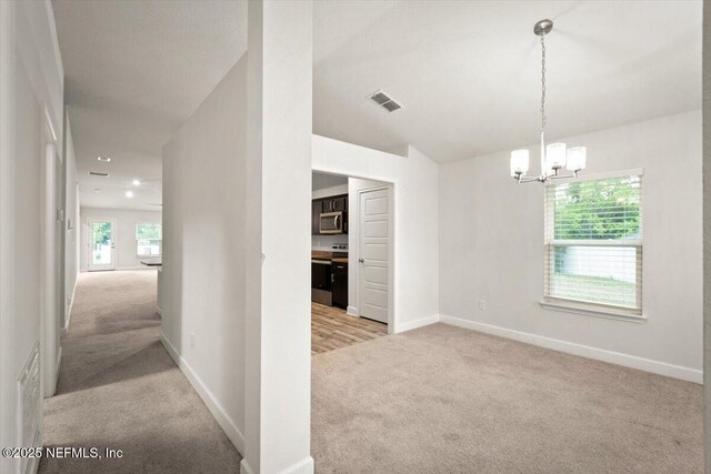 7271 Gateway Ct, Jacksonville, FL 32219 - corridor featuring light carpet, a chandelier, and baseboards