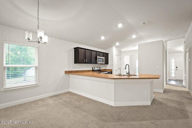 7271 Gateway Ct, Jacksonville, FL 32219 - kitchen featuring appliances with stainless steel finishes, a sink, light colored carpet, a chandelier, and baseboards