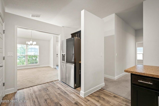 7271 Gateway Ct, Jacksonville, FL 32219 - hall with a chandelier, light wood-style flooring, and baseboards