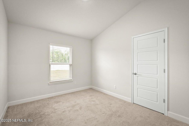 7271 Gateway Ct, Jacksonville, FL 32219 - carpeted empty room featuring lofted ceiling and baseboards
