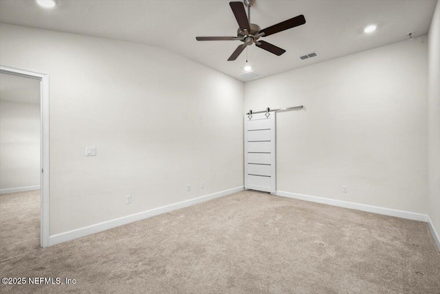 7271 Gateway Ct, Jacksonville, FL 32219 - carpeted spare room with baseboards, vaulted ceiling, ceiling fan, recessed lighting, and a barn door