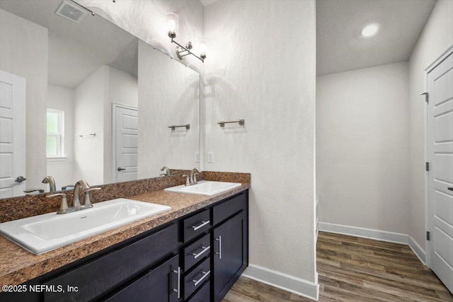 7271 Gateway Ct, Jacksonville, FL 32219 - full bathroom with baseboards, wood finished floors, and double vanity