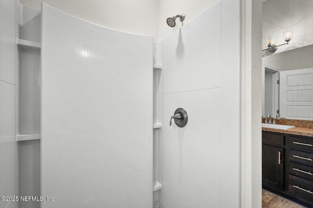 7271 Gateway Ct, Jacksonville, FL 32219 - bathroom with vanity, wood finished floors, and a shower