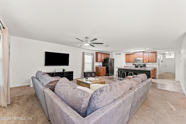 9087 Leicestershire Ct, Jacksonville, FL 32219 - living room featuring a ceiling fan, light carpet, and baseboards
