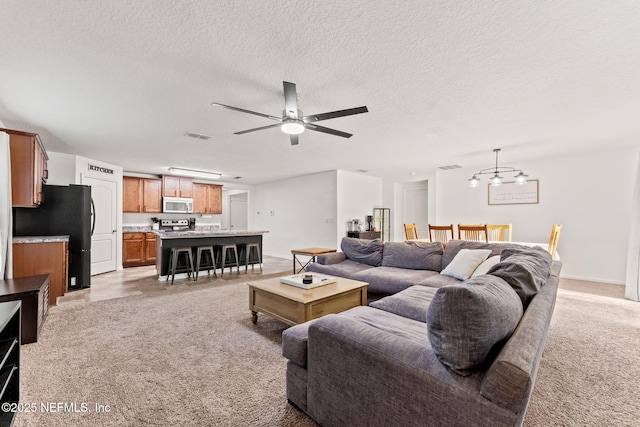 9087 Leicestershire Ct, Jacksonville, FL 32219 - living area featuring a ceiling fan, a textured ceiling, baseboards, light colored carpet, and visible vents