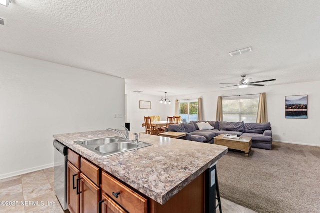 9087 Leicestershire Ct, Jacksonville, FL 32219 - kitchen featuring a sink, dishwasher, open floor plan, brown cabinetry, and visible vents