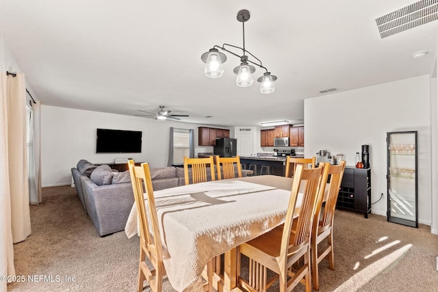 9087 Leicestershire Ct, Jacksonville, FL 32219 - dining area with light carpet, a wealth of natural light, visible vents, and ceiling fan