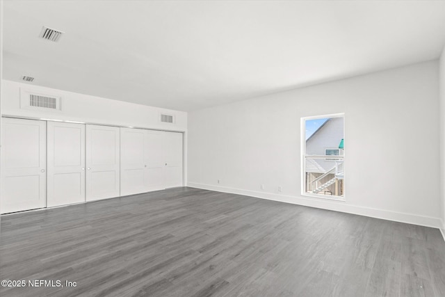 interior space featuring visible vents, baseboards, and wood finished floors