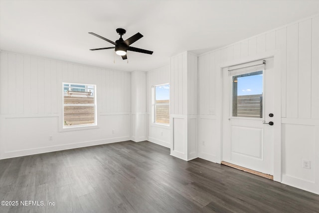 spare room featuring dark wood-style flooring, baseboards, and a ceiling fan