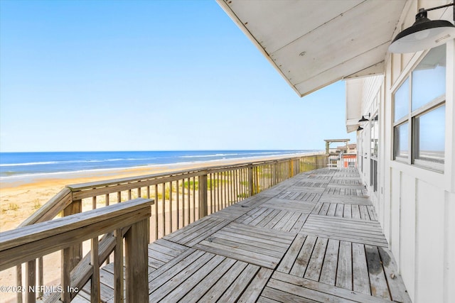 deck with a water view and a beach view