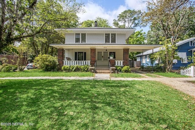 1516 Aberdeen St, Jacksonville, FL 32205 - traditional style home with a front yard, brick siding, a porch, and fence