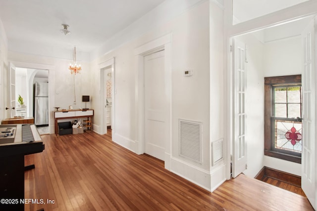 1516 Aberdeen St, Jacksonville, FL 32205 - corridor featuring baseboards, visible vents, hardwood / wood-style flooring, and an inviting chandelier