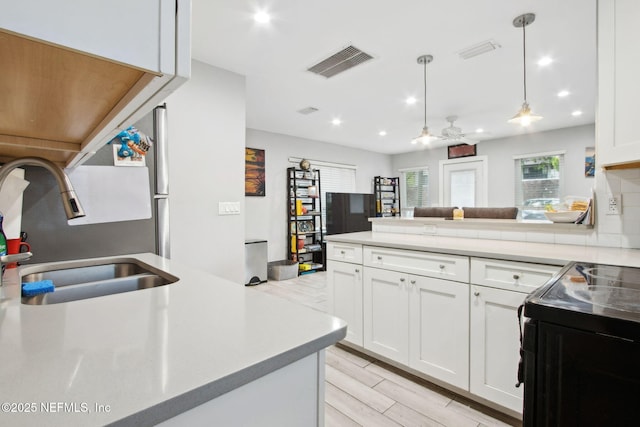 1516 Aberdeen St, Jacksonville, FL 32205 - kitchen featuring white cabinetry, a sink, a peninsula, and visible vents