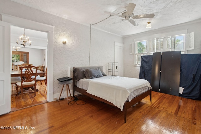 1516 Aberdeen St, Jacksonville, FL 32205 - bedroom featuring a textured ceiling, crown molding, hardwood / wood-style flooring, ceiling fan with notable chandelier, and a textured wall