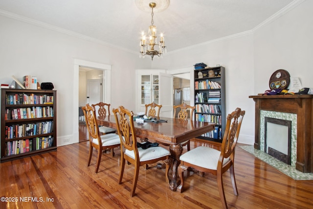 1516 Aberdeen St, Jacksonville, FL 32205 - dining space featuring a fireplace, ornamental molding, wood finished floors, and a notable chandelier