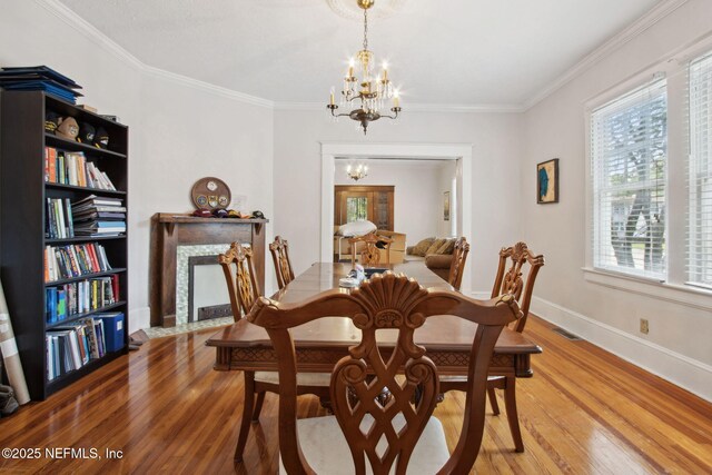 1516 Aberdeen St, Jacksonville, FL 32205 - dining area with light wood finished floors, visible vents, a notable chandelier, and ornamental molding